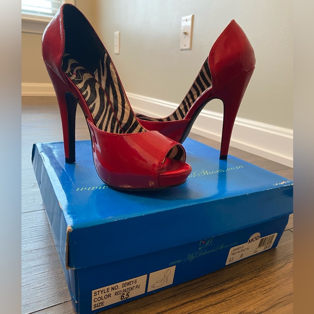 Size 6.5, red heels. Stored in original box, good condition.
